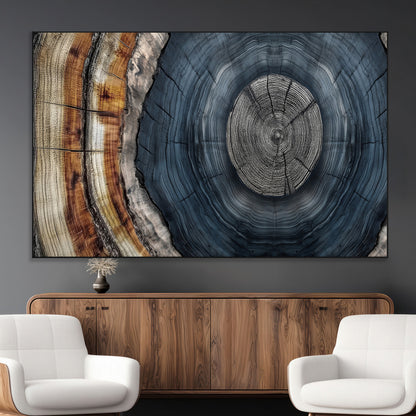A stunning close-up of a tree trunk showing the intricate, circular growth rings, showcasing the natural textures and rich contrasts in deep blues, browns, and silvers.