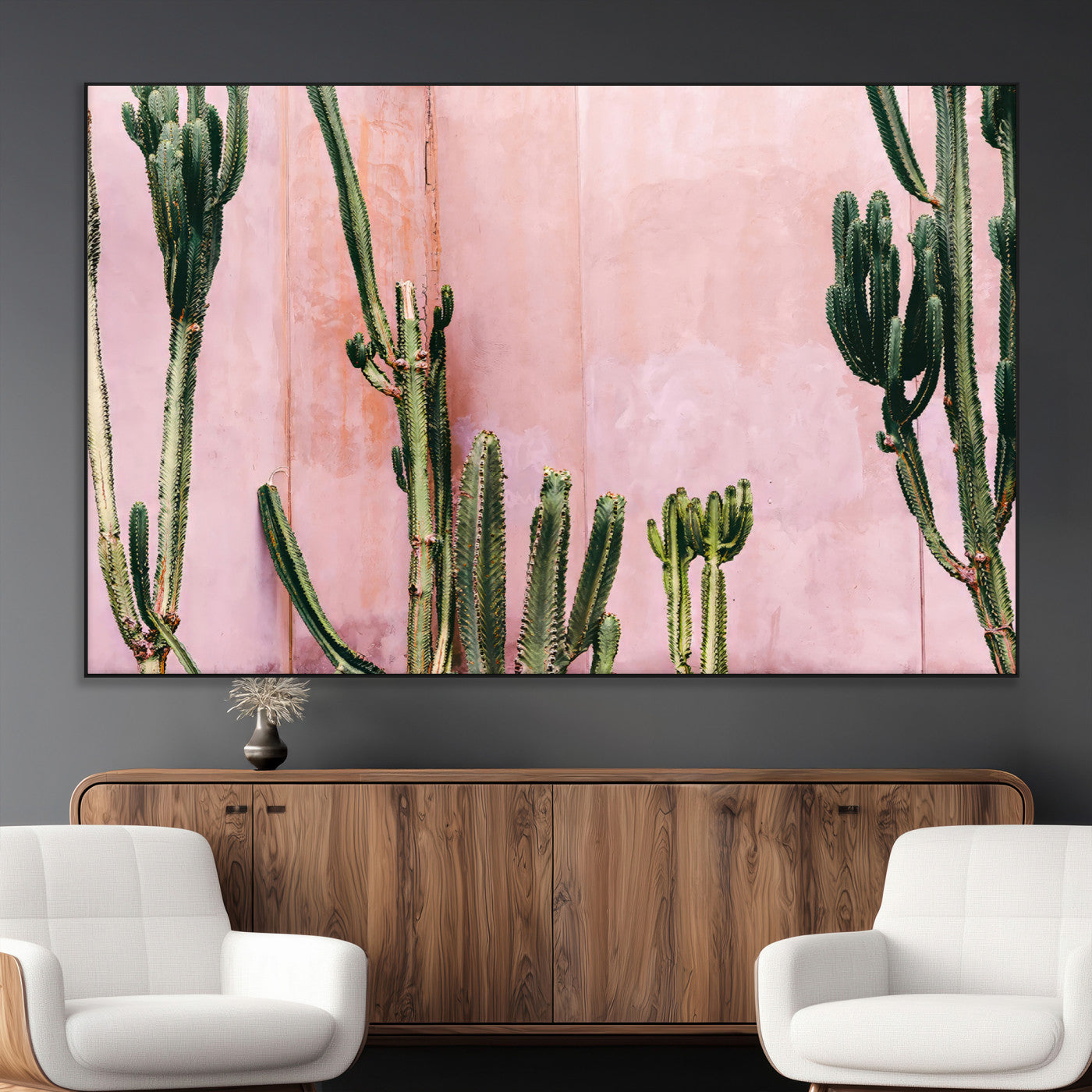 Framed canvas of tall green cacti against a soft pink wall, ideal for modern desert or colorful southwest-inspired home decor.