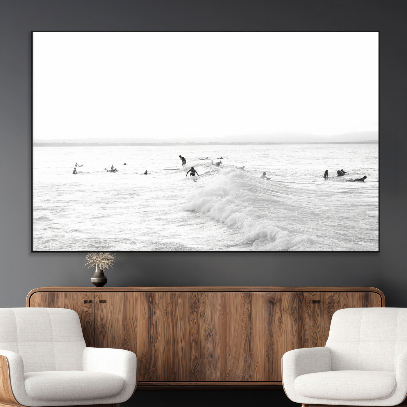 Monochrome photo of surfers riding and waiting on ocean waves, ideal for surf-themed or coastal energy wall decor.