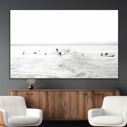 Monochrome photo of surfers riding and waiting on ocean waves, ideal for surf-themed or coastal energy wall decor.