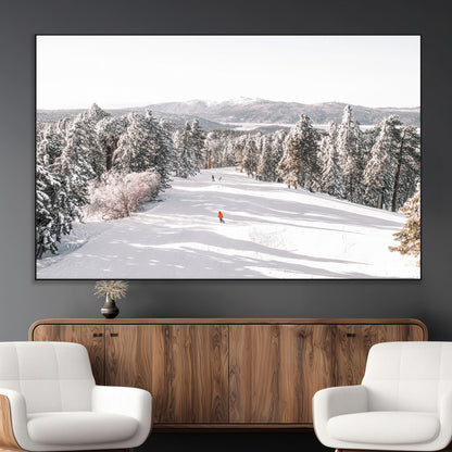 Bright ski trail lined with snow-covered pines and a skier in orange, perfect for alpine adventure or winter sports-inspired decor.
