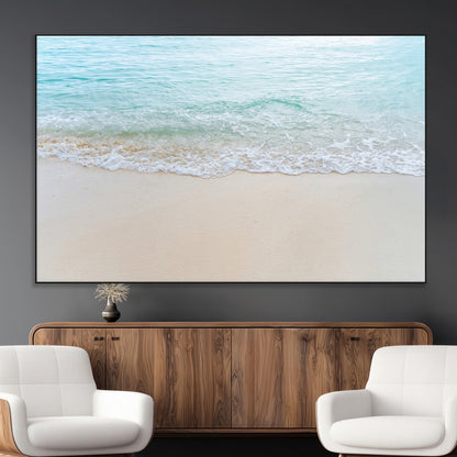 Soft shoreline with gentle aqua waves on smooth sand, ideal for minimalist coastal or pastel ocean-inspired home wall decor.