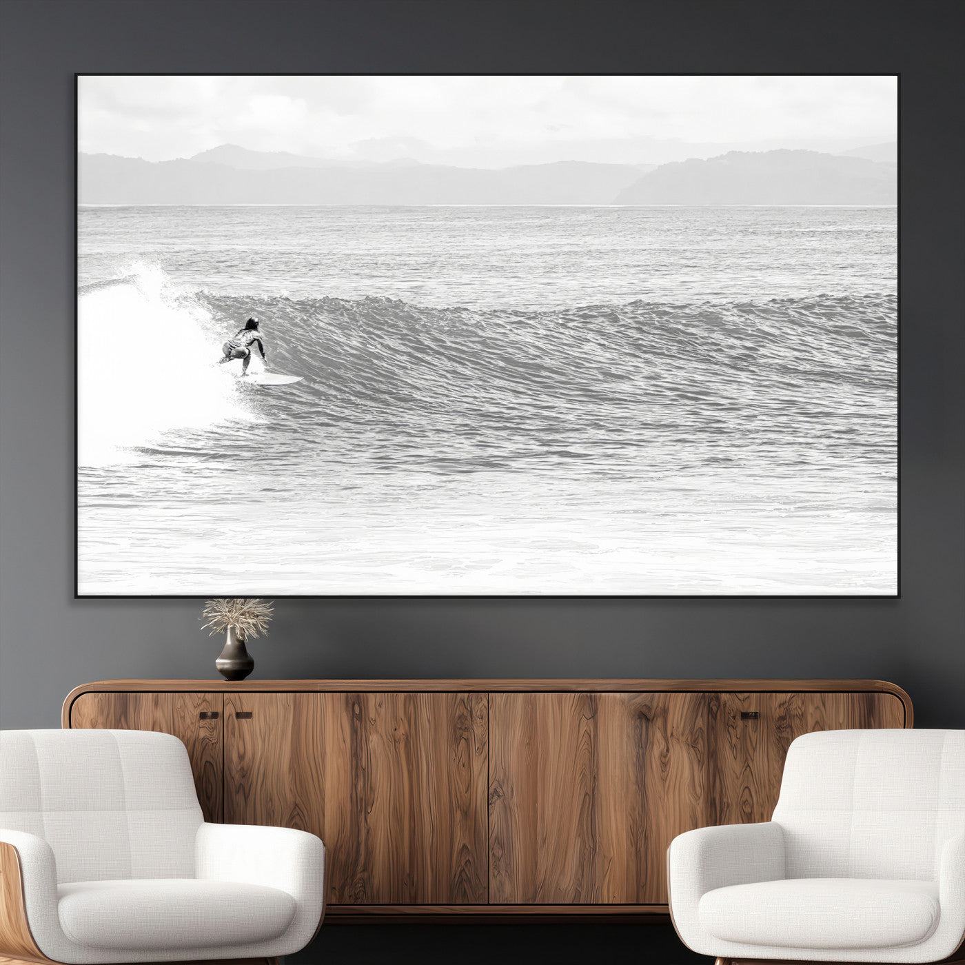 Monochrome photo of a surfer riding a wave with distant mountains, ideal for coastal motion or black and white surf-themed wall decor.
