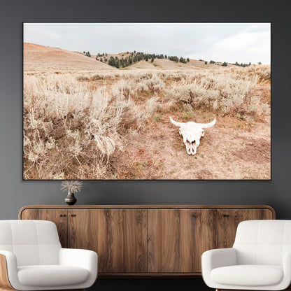 Rustic bull skull on dry sagebrush field under soft light, ideal for western minimal or desert prairie-style wall decoration.
