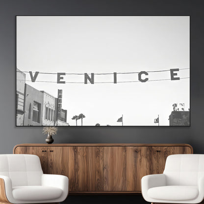 Black and white photo of Venice Beach sign and palm-lined street, perfect for urban coastal or minimalist LA-inspired wall decoration.