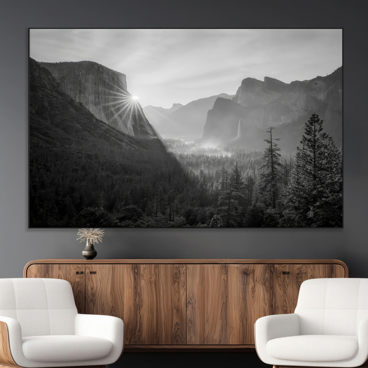 Black and white landscape of Yosemite with sun rays peeking over El Capitan, ideal for moody nature or modern rustic decor.