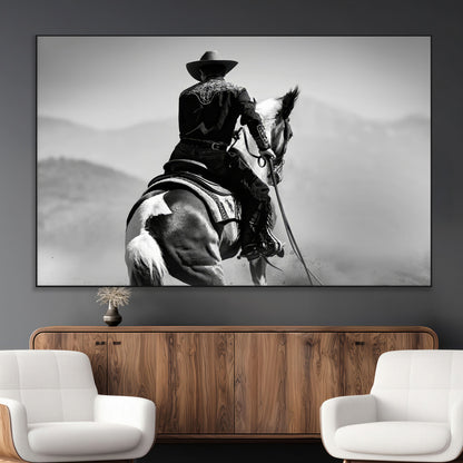 Black and white canvas of a cowboy on horseback with moody tones, perfect for rustic western or country-inspired home decor.