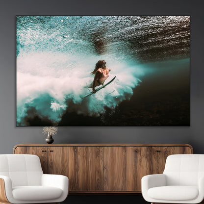 Vibrant underwater photo of a female surfer diving through turquoise waves, perfect for coastal boho or surf-inspired home decor.