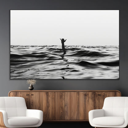 Black and white ocean with a hand making a surfer sign among dark waves, creating a dramatic and minimalist seascape with bold contrast.