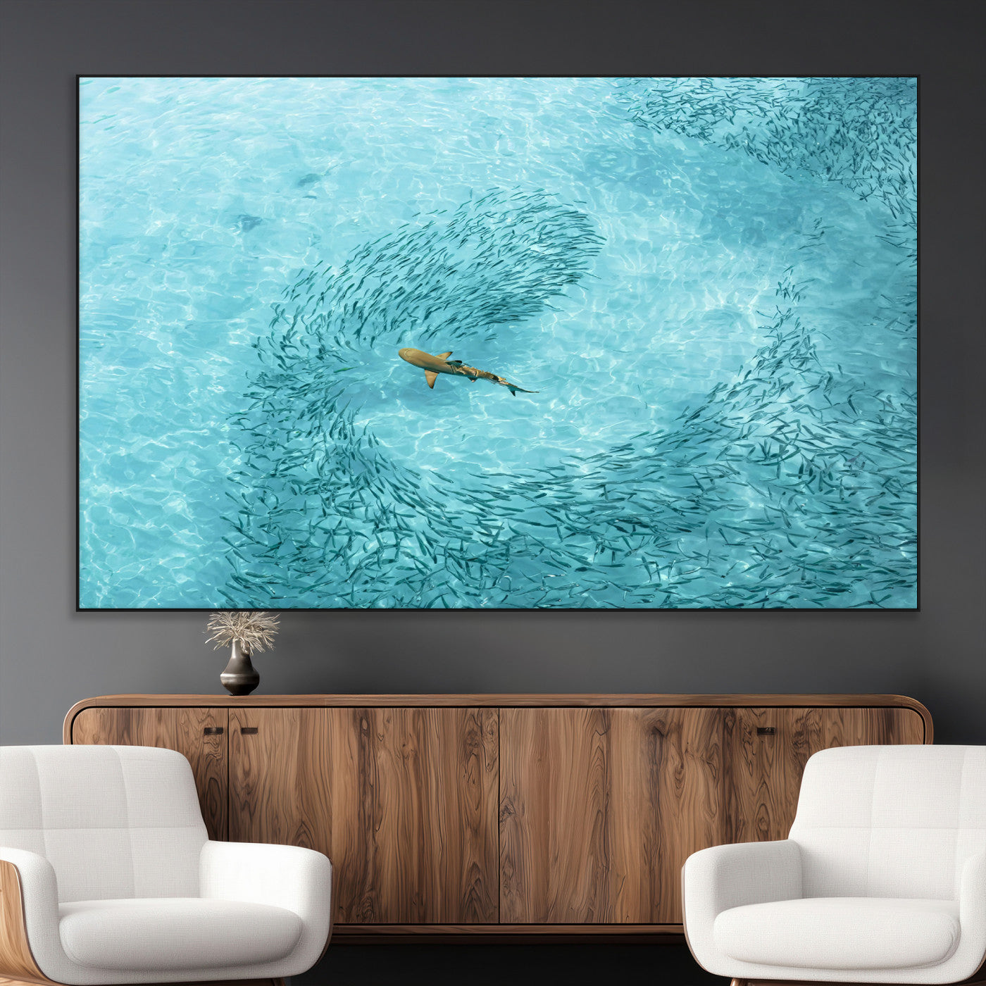 Aerial view of a shark swimming through a swirl of fish in clear turquoise waters, perfect for calm coastal or beach house decor.