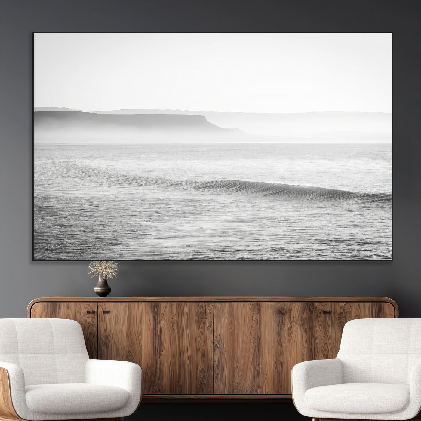 A black and white minimalist seascape featuring soft rolling waves and misty distant cliffs, creating a serene and timeless coastal atmosphere.