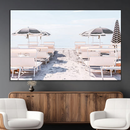 A serene minimalist beach scene featuring striped umbrellas, soft pastel sand, and an elegant lounge setup, creating a tranquil and stylish coastal retreat.