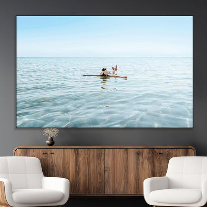 A peaceful minimalist scene of a person floating on crystal-clear water, surrounded by a vast open horizon, capturing relaxation and serenity in a tranquil aquatic setting.