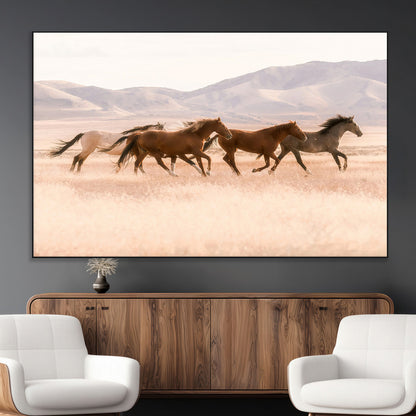 A herd of wild horses galloping through a sunlit desert plain with mountains in the background, perfect for rustic or western-themed wall decor.