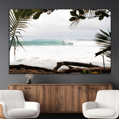 Tropical beach view with palm trees and surfer riding a wave, perfect for boho or coastal-inspired interior wall decor.
