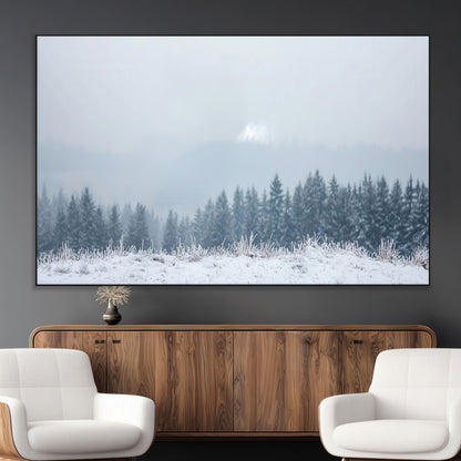 Snow-covered forest under misty sky, soft light breaking through clouds, ideal for minimalist or Nordic-inspired home decor.