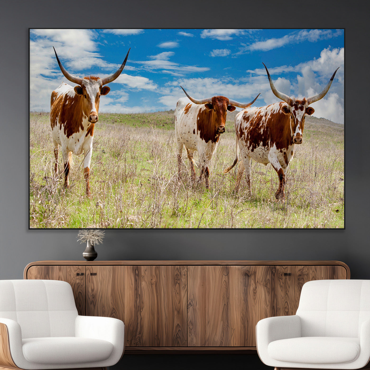 Three Texas longhorn cattle standing in dry grass under a bright blue sky, ideal for farmhouse or western rustic home decor.