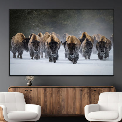 A herd of American bisons walking through deep snow in a forest, evoking a powerful rustic wilderness mood for western-style interiors.