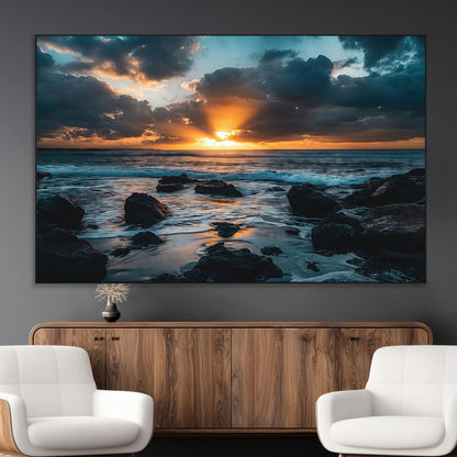An awe-inspiring sunset over the ocean with rays of light piercing through dramatic clouds, creating a beautiful seascape with rocks in the foreground.