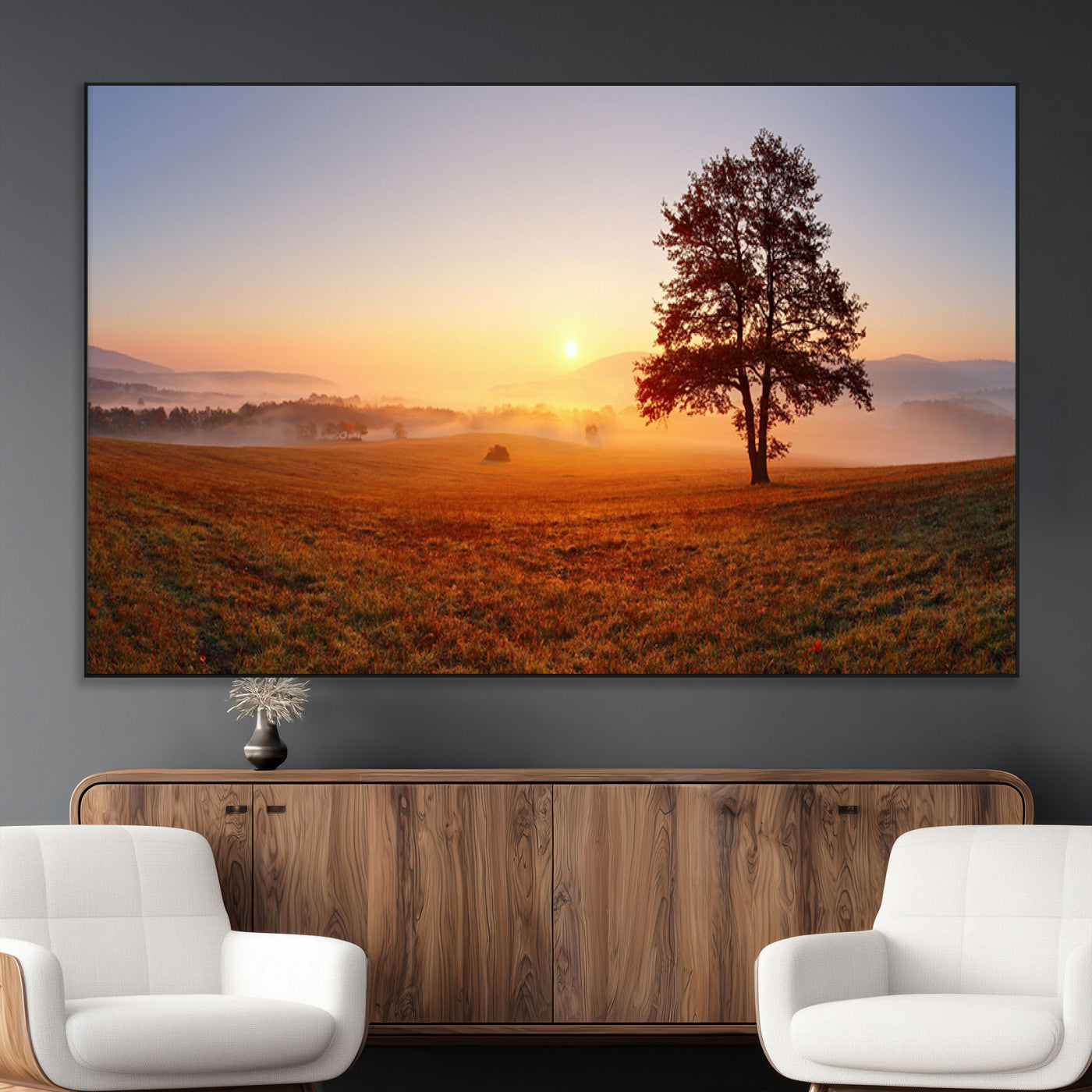 A tranquil landscape at sunrise with a mist-covered field and a lone tree, creating a peaceful and natural atmosphere.