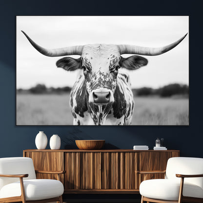 Capture the strength and elegance of nature with this striking black and white portrait of a longhorn cow. Its powerful presence makes a bold statement in any room.