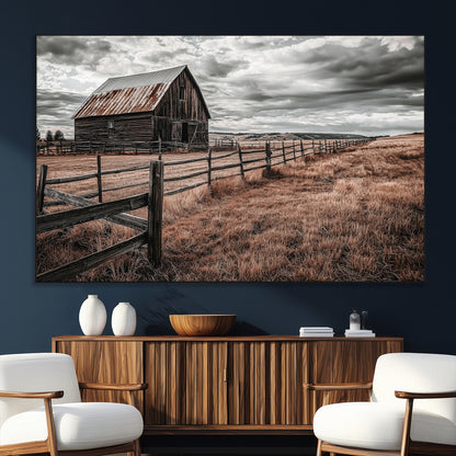Framed canvas of a rustic barn under a moody sky with weathered fence and dark fields, ideal for farmhouse or rural-style wall decor.
