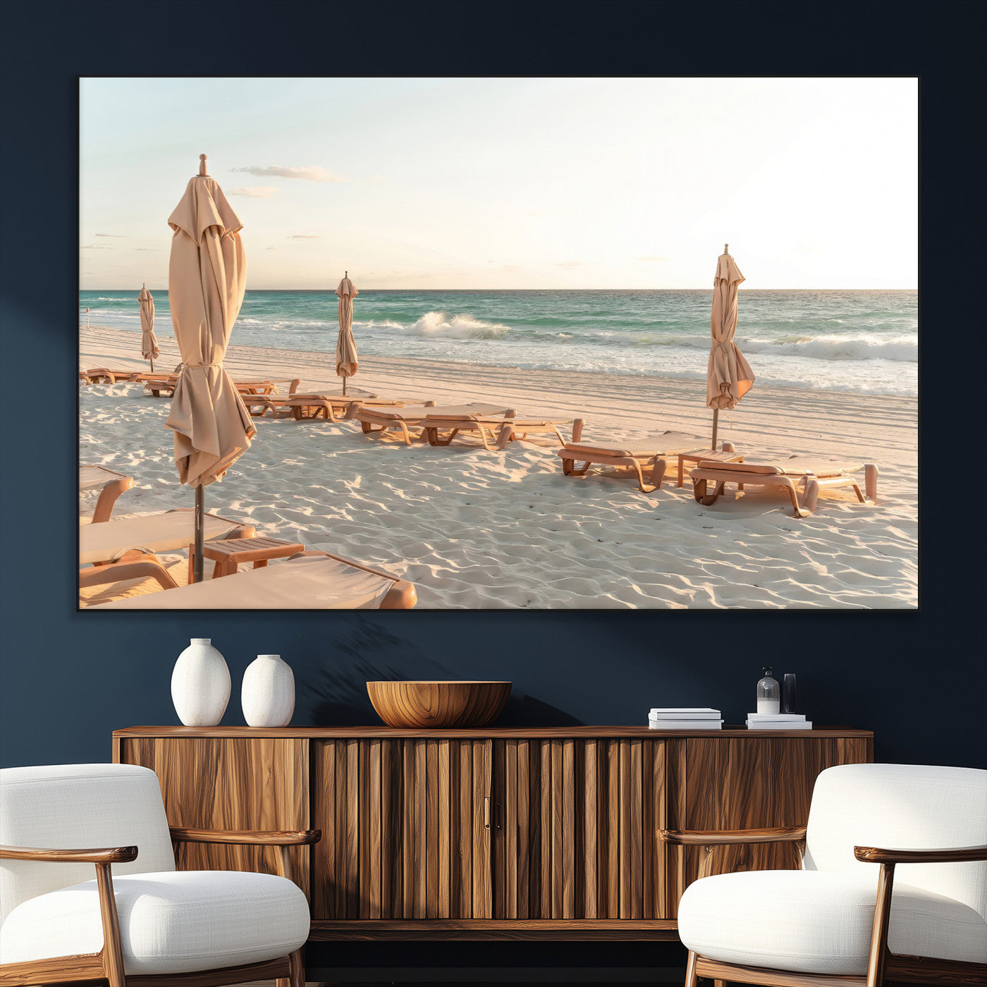 Minimalist photo of empty beach loungers and umbrellas on soft sand, ideal for calm seaside or pastel coastal-style home decor.