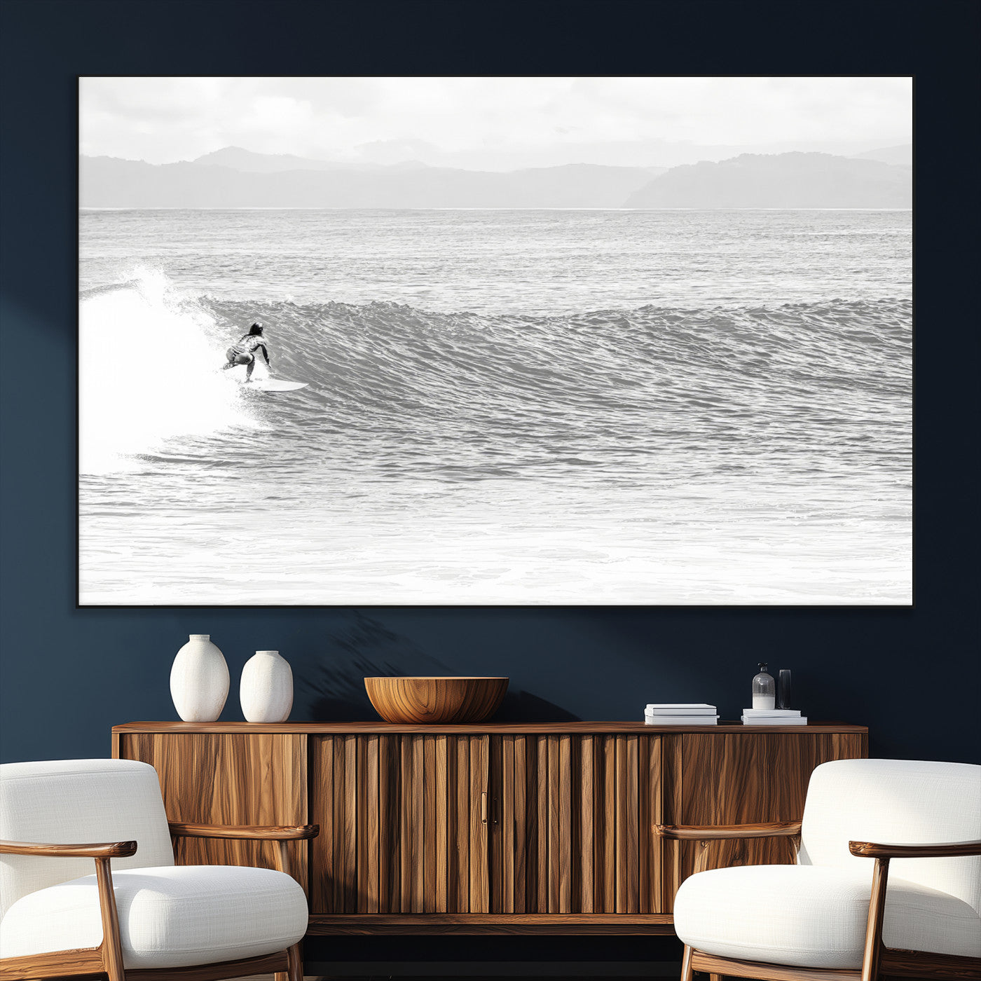 Monochrome photo of a surfer riding a wave with distant mountains, ideal for coastal motion or black and white surf-themed wall decor.