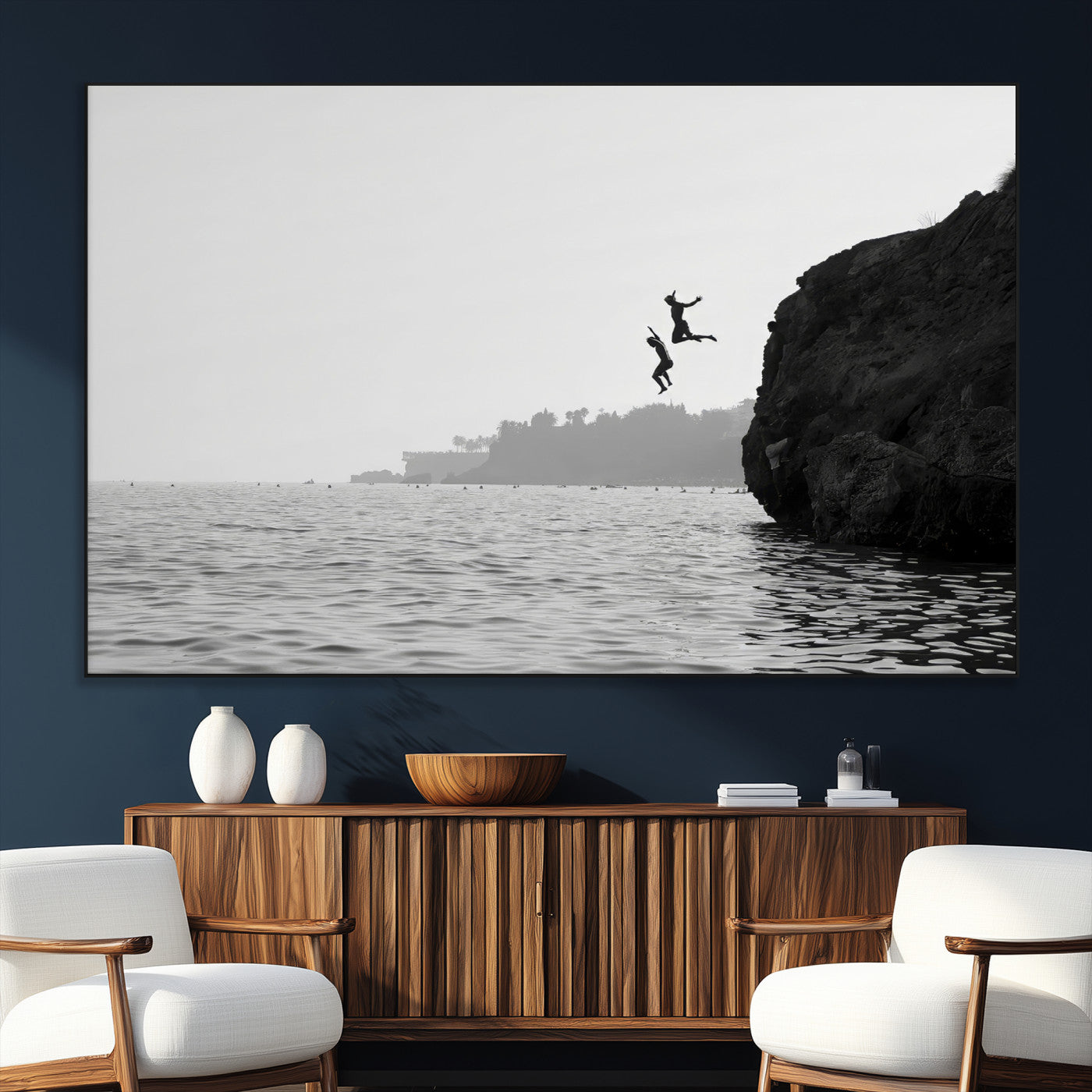 Black and white canvas of two figures cliff jumping into the sea, captured with moody tones, ideal for modern coastal or adventure-themed home decor.   2/2