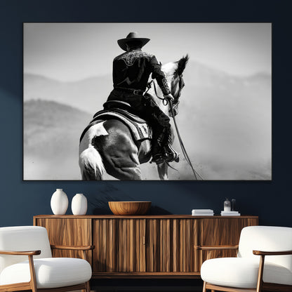 Black and white canvas of a cowboy on horseback with moody tones, perfect for rustic western or country-inspired home decor.
