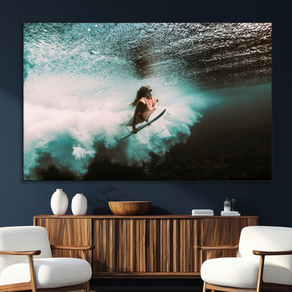 Vibrant underwater photo of a female surfer diving through turquoise waves, perfect for coastal boho or surf-inspired home decor.