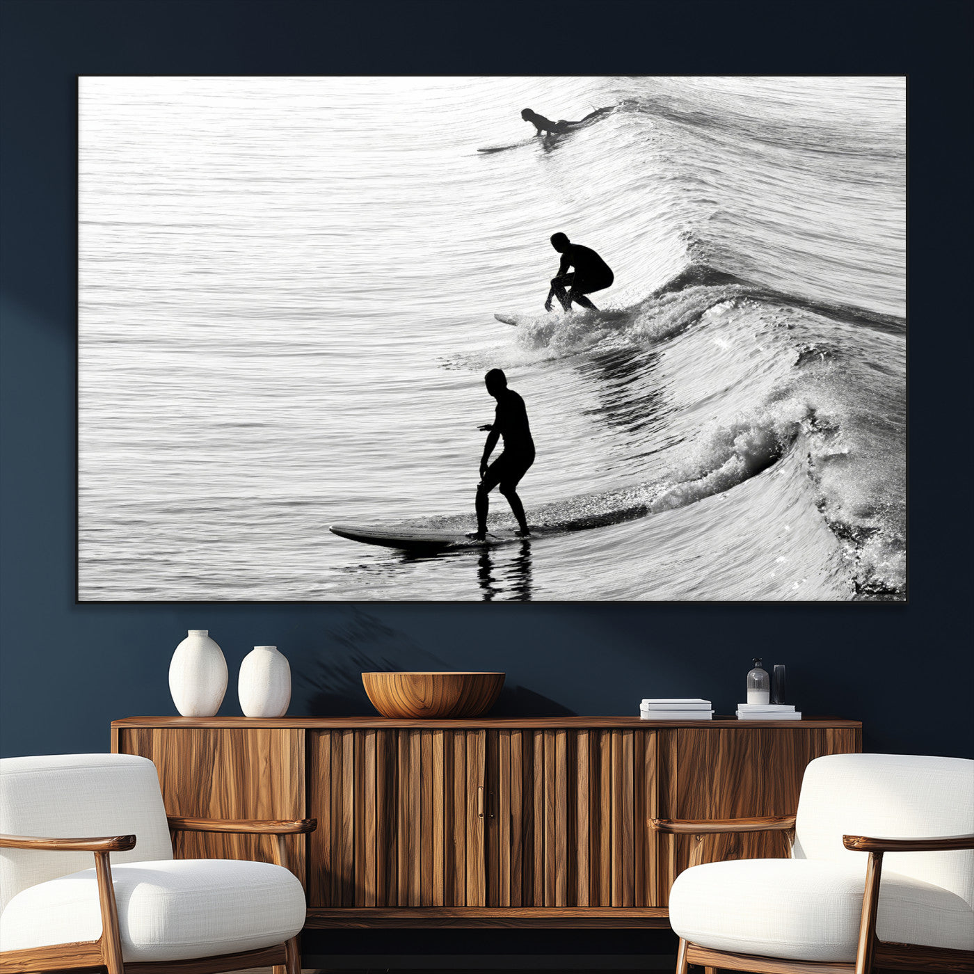 Black and white photo of surfers riding waves in a moody, high-contrast scene, ideal for modern coastal or surf-inspired home decor.
