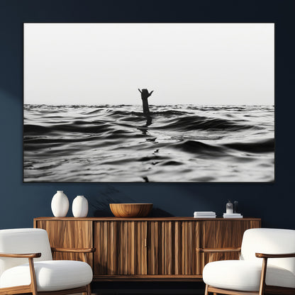 Black and white ocean with a hand making a surfer sign among dark waves, creating a dramatic and minimalist seascape with bold contrast.