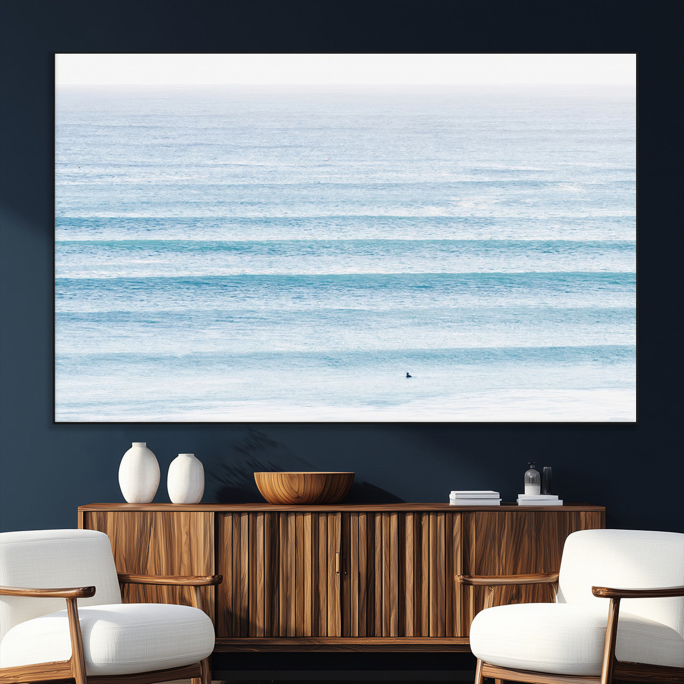 Minimalist ocean view with soft blue waves and a lone surfer, creating a serene and airy coastal aesthetic, perfect for tranquil home decor.