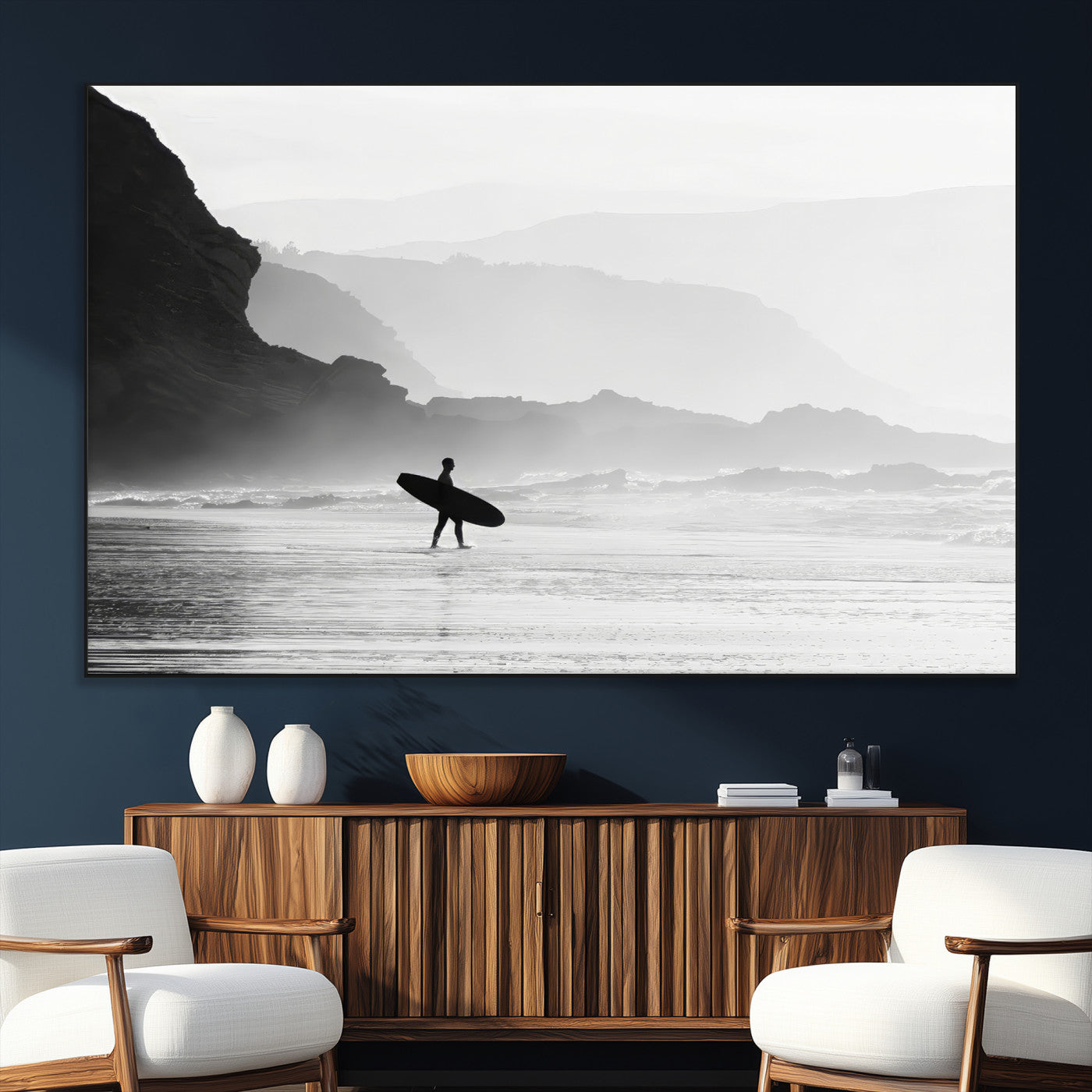 A lone surfer walking along a misty beach with cliffs in the background, carrying their board, capturing a serene and minimal ocean moment.
