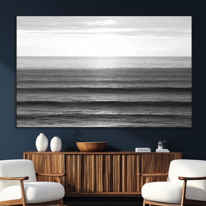 Minimalist black and white ocean view with layered waves reflecting sunlight, evoking a sense of calm and coastal serenity.