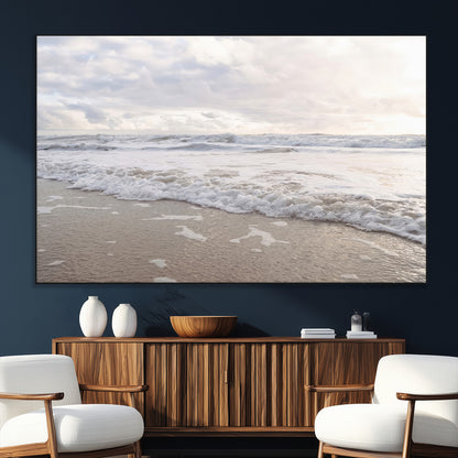 Peaceful ocean waves rolling onto the sandy shore under soft light, perfect for neutral or coastal minimalist decor themes.
