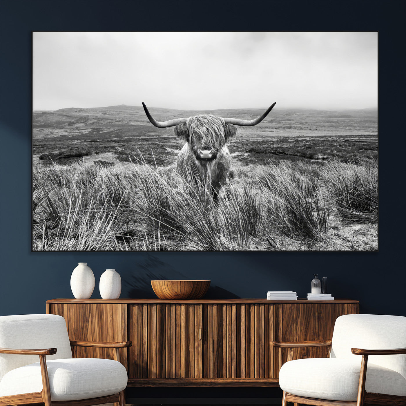 A black and white portrait of a Highland cow in a foggy Scottish countryside, capturing a rustic aesthetic and tranquil farm escape.