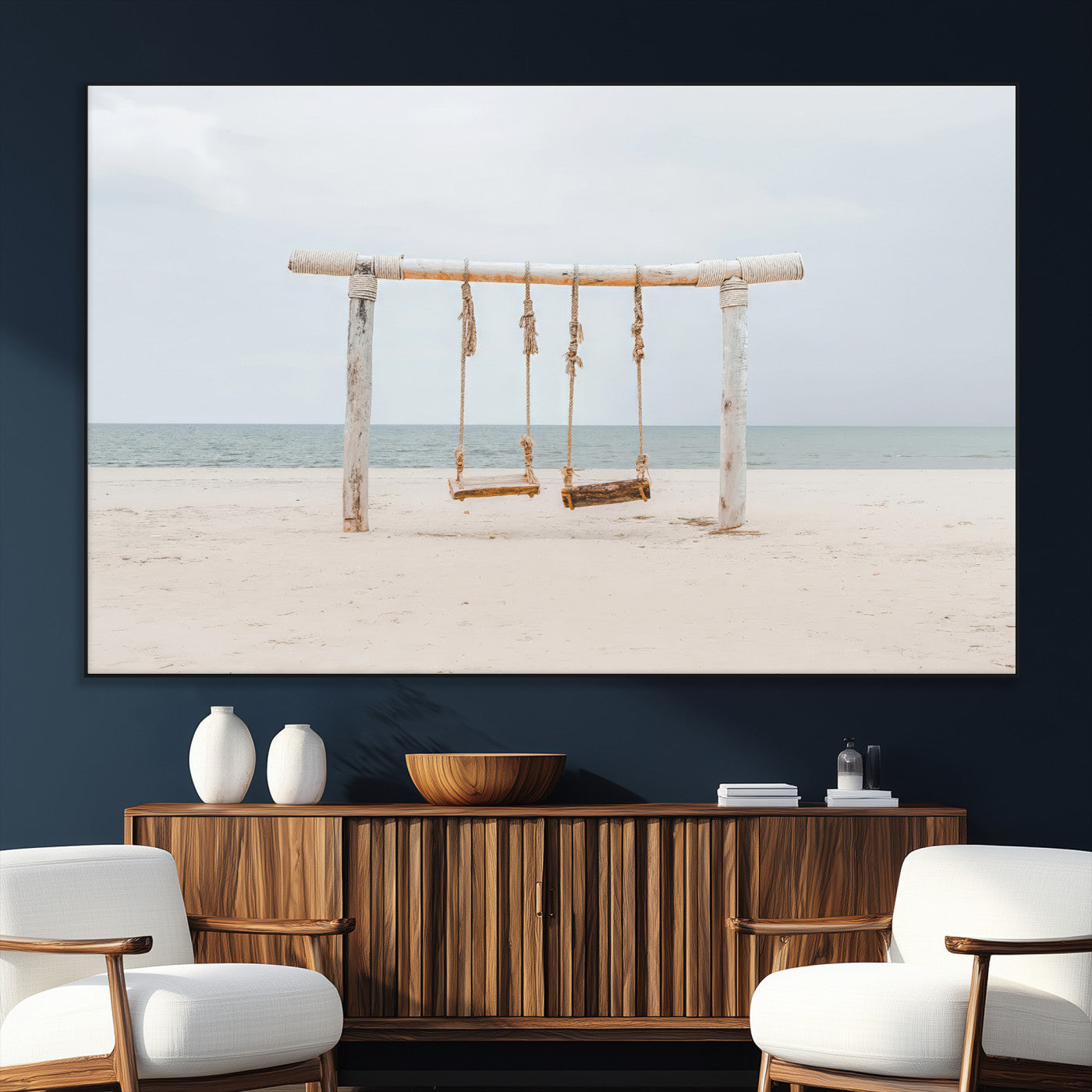A rustic wooden beach swing stands on a serene sandy shore with an ocean horizon in the background, creating a tranquil and dreamy coastal escape.