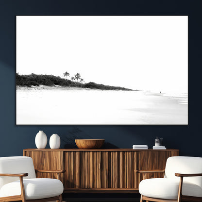A black and white minimalist coastal scene with a vast open beach, distant palm trees, and a lone figure walking along the shoreline, evoking serenity and solitude.