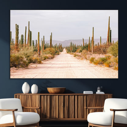 A desert road lined with saguaro cacti under a golden sky, creating a warm southwestern feel, perfect for boho or rustic decor.