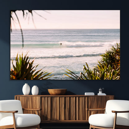 Canvas of a lone surfer riding a pastel wave at sunrise, perfect for tropical or coastal-themed spaces with a relaxed, airy vibe.