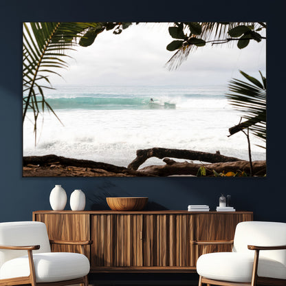 Tropical beach view with palm trees and surfer riding a wave, perfect for boho or coastal-inspired interior wall decor.