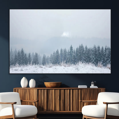 Snow-covered forest under misty sky, soft light breaking through clouds, ideal for minimalist or Nordic-inspired home decor.