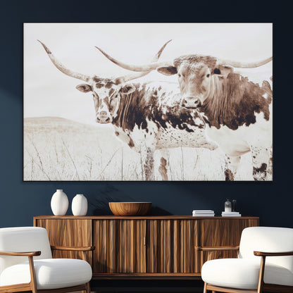 Two longhorn cows standing in a sepia-toned pasture with soft light, ideal for rustic or farmhouse-themed neutral wall decor.