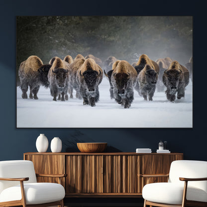 A herd of American bisons walking through deep snow in a forest, evoking a powerful rustic wilderness mood for western-style interiors.