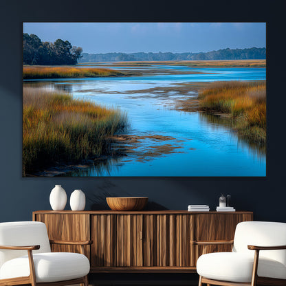 A peaceful marshland scene with calm blue water reflecting the surrounding grasses and trees, capturing the beauty of nature in a serene landscape.