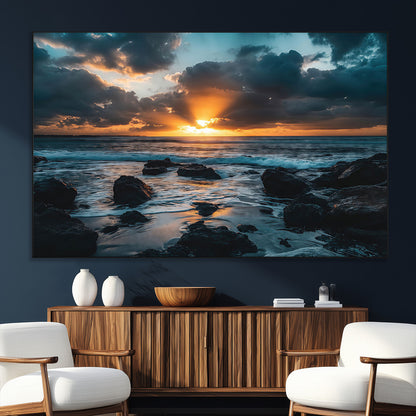 An awe-inspiring sunset over the ocean with rays of light piercing through dramatic clouds, creating a beautiful seascape with rocks in the foreground.