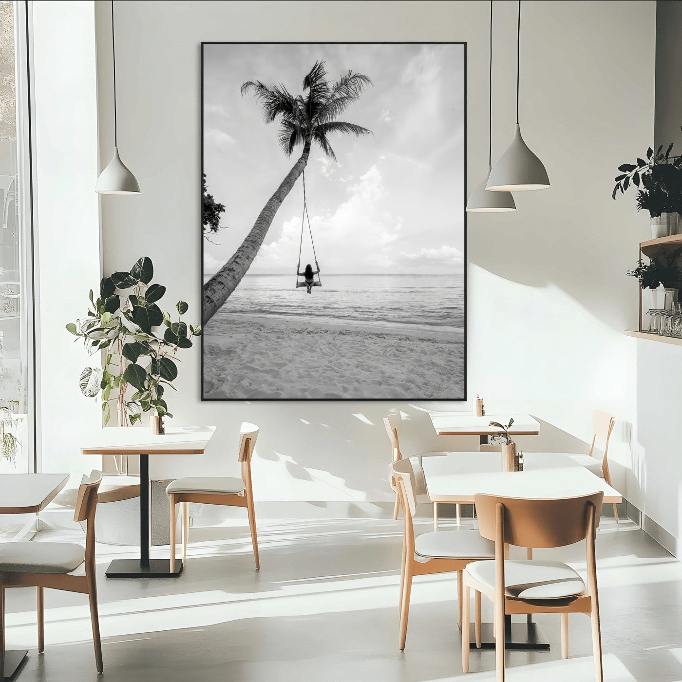 Monochrome photo of a woman swinging from a palm tree on a serene beach, ideal for minimalist or tropical coastal decor.