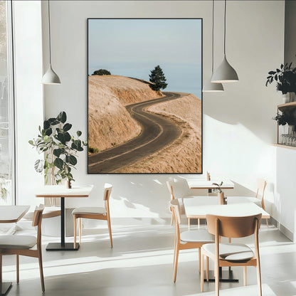 Earth-toned photograph of a winding road through golden hills, ideal for neutral or rustic-themed decor with a calming travel vibe.